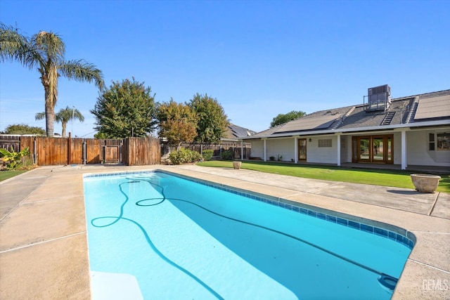 view of pool featuring a patio area and a yard