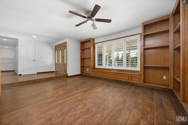 unfurnished living room with ceiling fan and dark hardwood / wood-style flooring