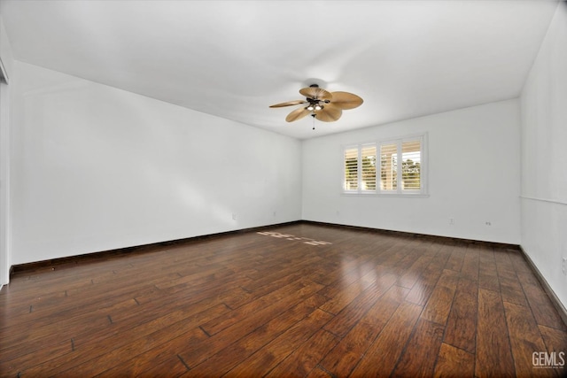 empty room with ceiling fan and dark wood-type flooring