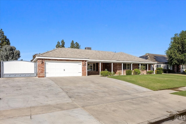 ranch-style home featuring a garage and a front lawn