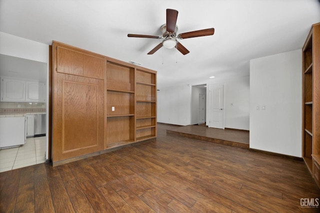 unfurnished living room with ceiling fan and dark wood-type flooring