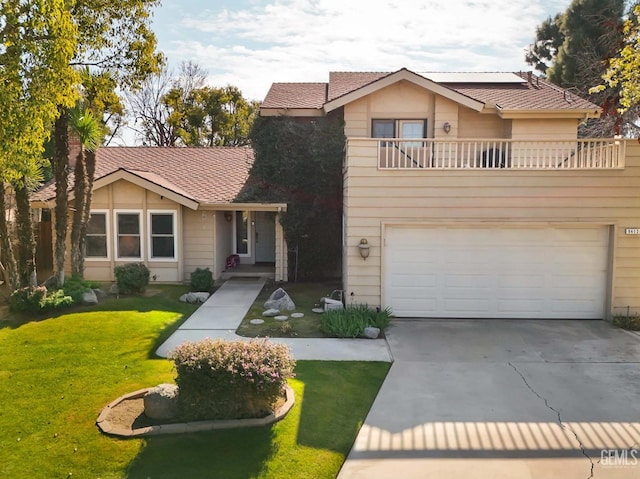 front of property featuring a garage, a balcony, and a front lawn