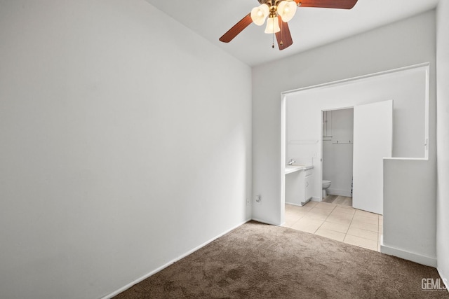 2310 B St, Bakersfield, CA 93301 - unfurnished bedroom with light carpet, ensuite bathroom, light tile patterned flooring, and ceiling fan