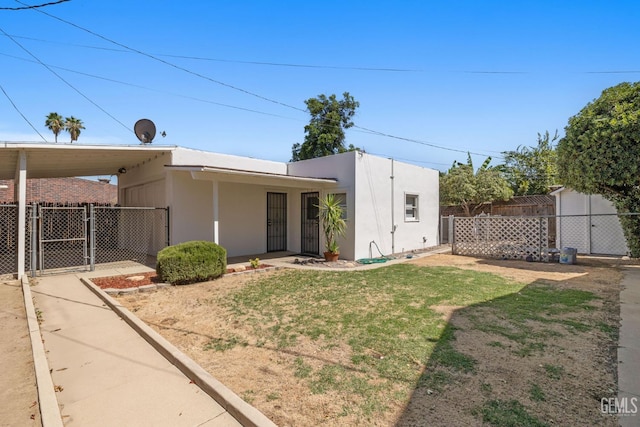 2310 B St, Bakersfield, CA 93301 - rear view of house featuring a gate and stucco siding