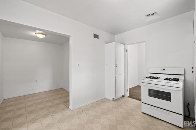 2310 B St, Bakersfield, CA 93301 - kitchen with white range with gas stovetop and light flooring
