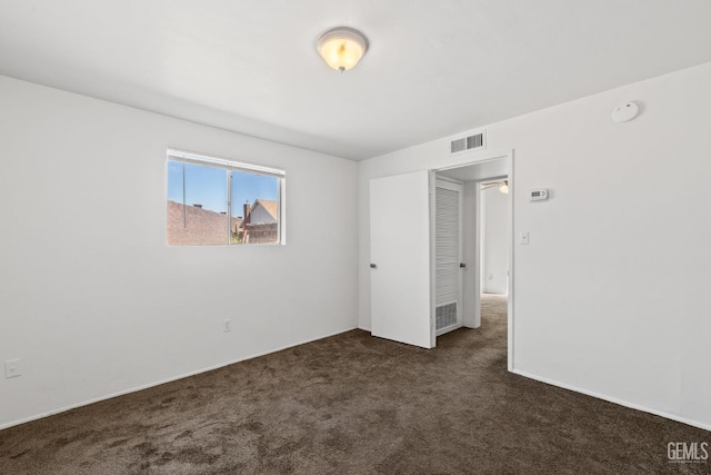 2310 B St, Bakersfield, CA 93301 - spare room featuring dark colored carpet and a smoke detector