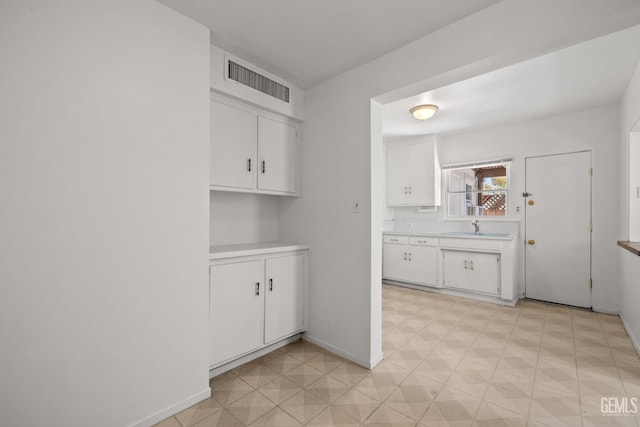 2310 B St, Bakersfield, CA 93301 - kitchen with light countertops, light floors, and white cabinets