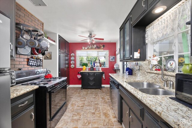 3808 Navajo Ave, Bakersfield, CA 93309 - kitchen with black gas range oven, dishwasher, ceiling fan, light stone finish floors, and light stone counters
