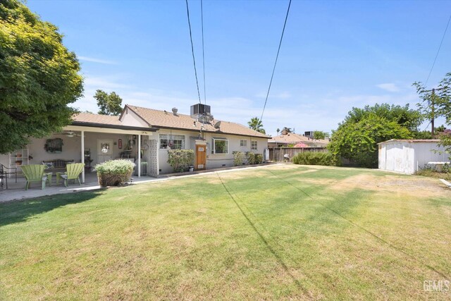 3808 Navajo Ave, Bakersfield, CA 93309 - rear view of property with a storage shed and a patio