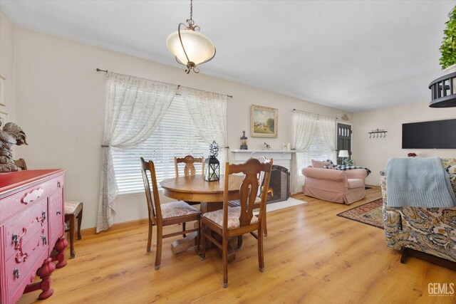3808 Navajo Ave, Bakersfield, CA 93309 - dining space featuring light wood-type flooring and a brick fireplace