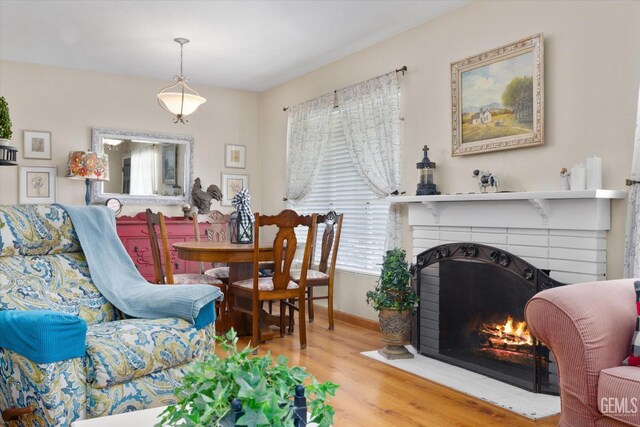 3808 Navajo Ave, Bakersfield, CA 93309 - living room with wood finished floors and a brick fireplace