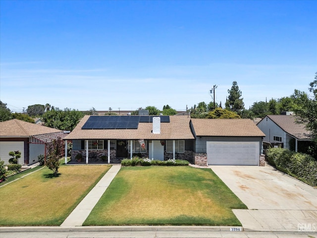 3808 Navajo Ave, Bakersfield, CA 93309 - ranch-style home with covered porch, a front yard, a garage, and roof mounted solar panels