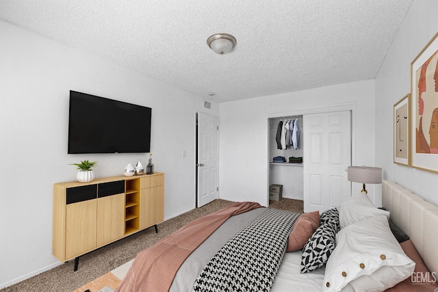 carpeted bedroom with a closet and a textured ceiling