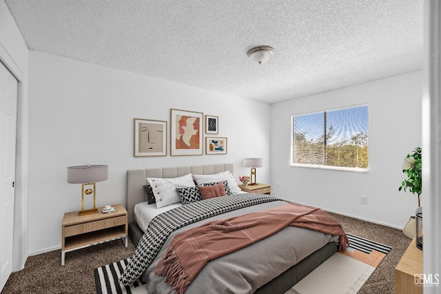 carpeted bedroom featuring a textured ceiling, a closet, and baseboards