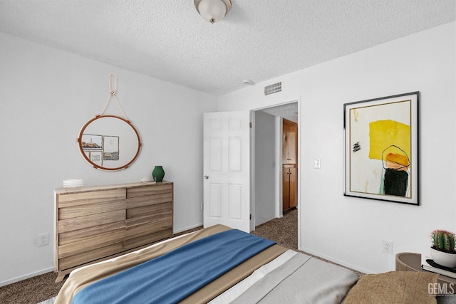 bedroom featuring carpet, visible vents, a textured ceiling, and baseboards