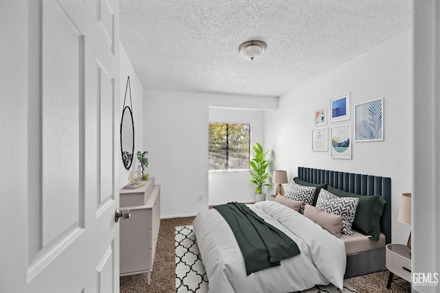 bedroom with a textured ceiling and carpet flooring