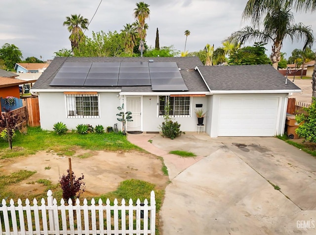 ranch-style home featuring an attached garage, a shingled roof, fence, and stucco siding