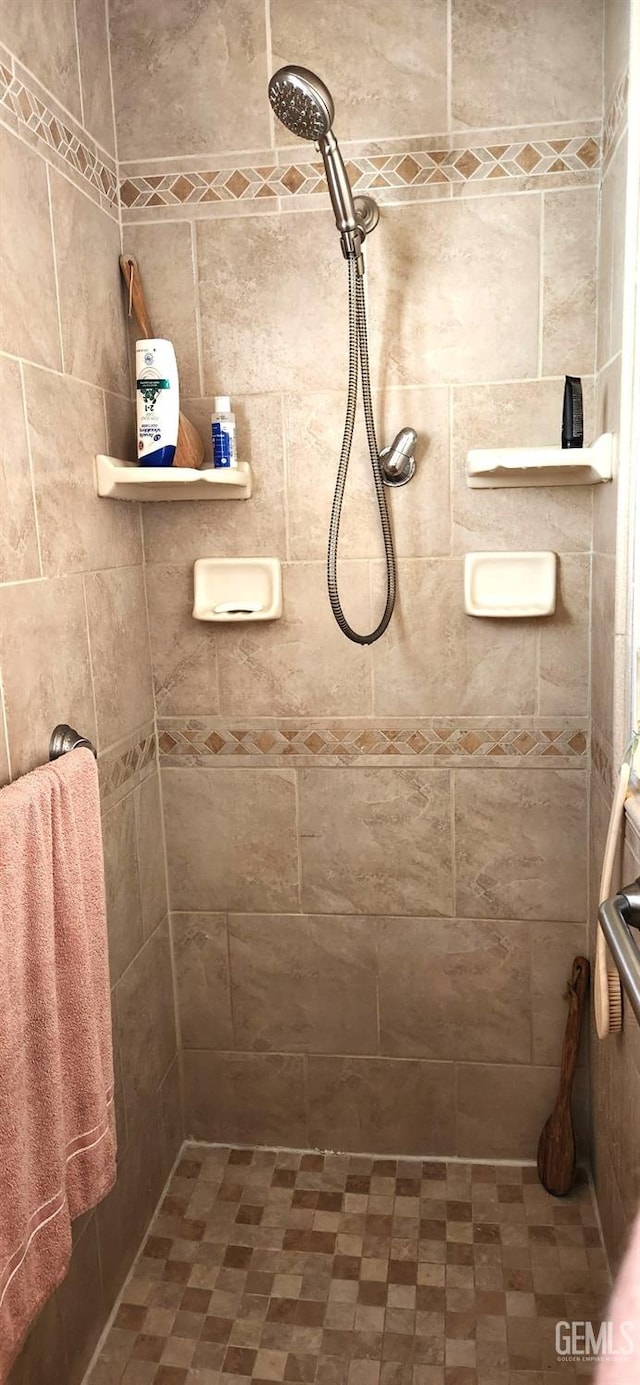 full bath with a tile shower