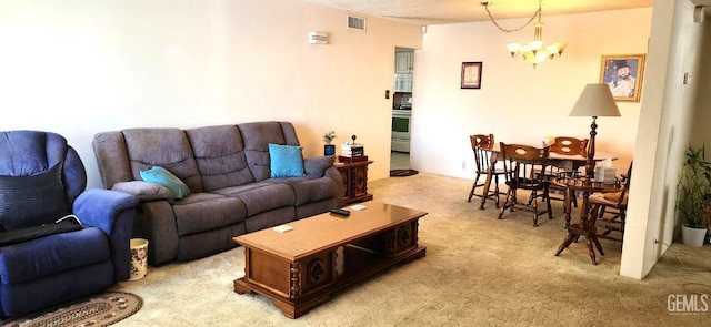 living area with visible vents, a notable chandelier, and light colored carpet