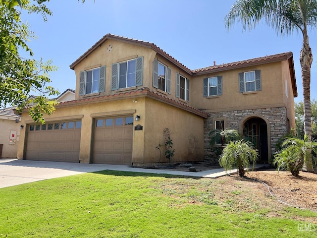 mediterranean / spanish home with a garage and a front lawn