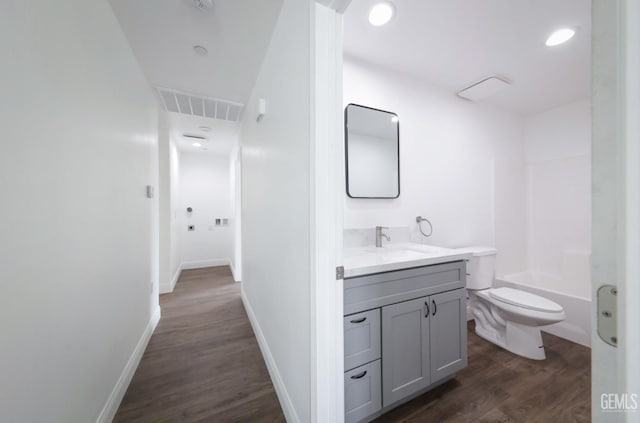 2625 Security Ave, Bakersfield, CA 93306 - full bathroom with vanity, toilet, baseboards, wood finished floors, and visible vents