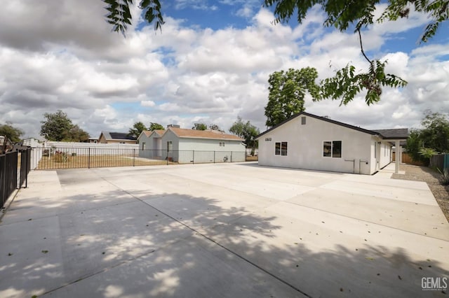 2625 Security Ave, Bakersfield, CA 93306 - view of home's exterior with a patio, stucco siding, and fence