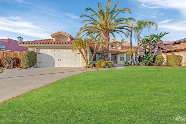 view of front of home with a front yard, driveway, a tiled roof, and an attached garage