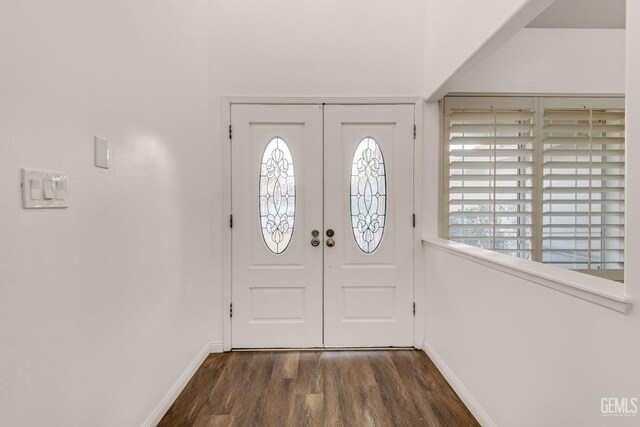 foyer featuring baseboards, dark wood-style flooring, and french doors