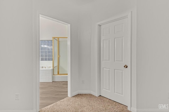 interior space featuring ensuite bath and baseboards