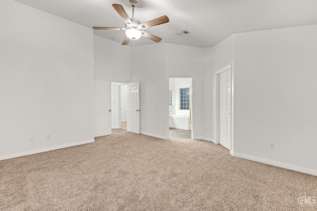 unfurnished bedroom featuring visible vents, a ceiling fan, carpet flooring, ensuite bath, and baseboards