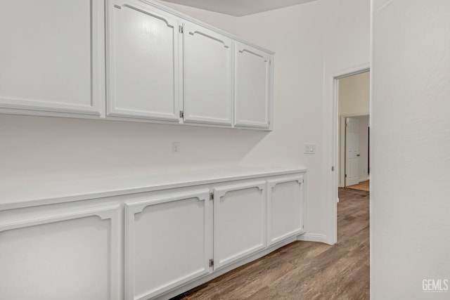 interior space featuring light countertops, light wood-style floors, and white cabinets