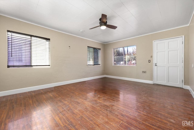 unfurnished room featuring ceiling fan, crown molding, and dark hardwood / wood-style flooring