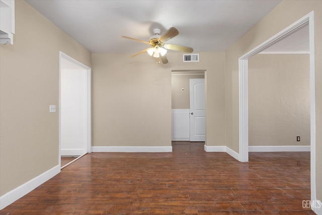 unfurnished room with dark hardwood / wood-style floors and ceiling fan