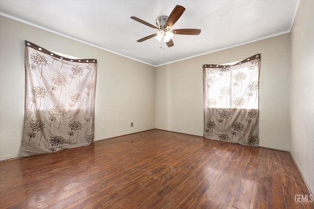 empty room with dark wood-type flooring, ornamental molding, and ceiling fan