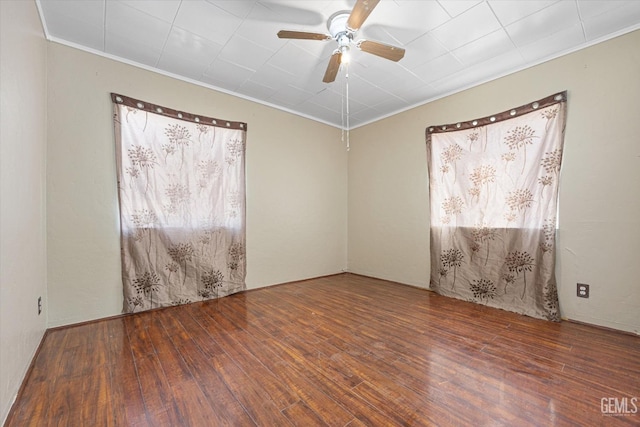 spare room with ceiling fan, ornamental molding, and dark hardwood / wood-style flooring