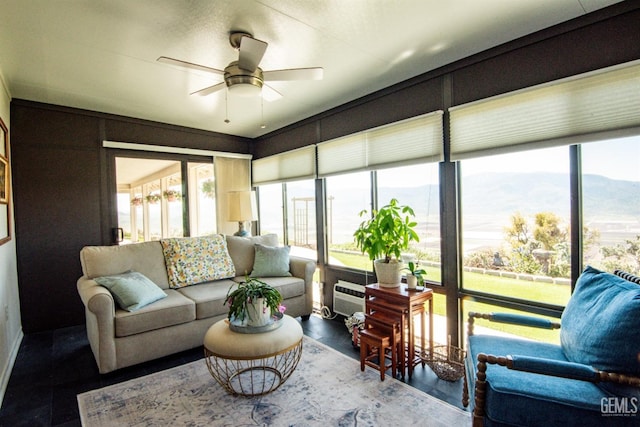 sunroom with a mountain view and an AC wall unit