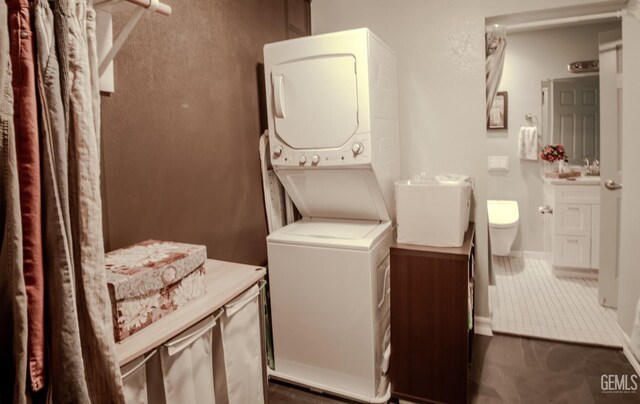 washroom featuring stacked washer / drying machine