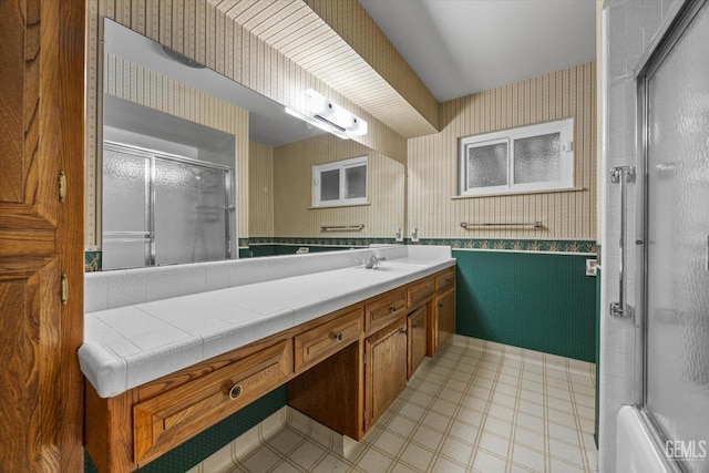 6309 Desert Hills Ave, Bakersfield, CA 93309 - full bathroom with wallpapered walls, a shower with door, vanity, and a wainscoted wall