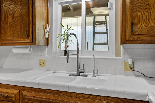 6309 Desert Hills Ave, Bakersfield, CA 93309 - kitchen with brown cabinets, light countertops, backsplash, and healthy amount of natural light