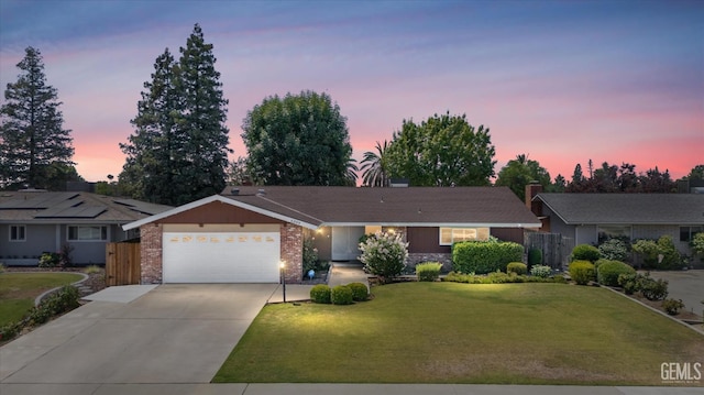 6309 Desert Hills Ave, Bakersfield, CA 93309 - single story home featuring a garage, driveway, brick siding, and a front lawn
