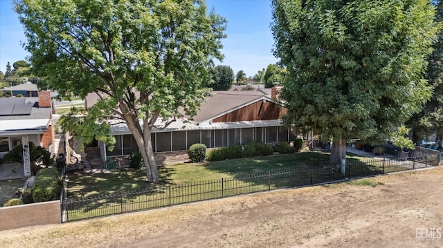 6309 Desert Hills Ave, Bakersfield, CA 93309 - view of front of property with a fenced backyard, a chimney, and a sunroom