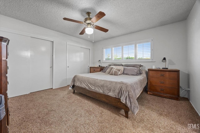 6309 Desert Hills Ave, Bakersfield, CA 93309 - bedroom featuring two closets, carpet flooring, a textured ceiling, and a ceiling fan
