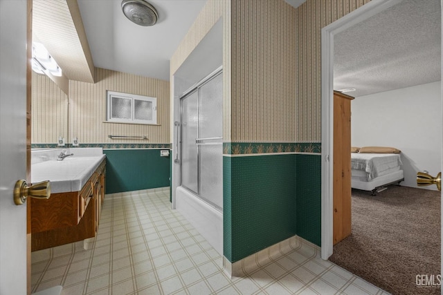 6309 Desert Hills Ave, Bakersfield, CA 93309 - full bathroom featuring wallpapered walls, vanity, bath / shower combo with glass door, ensuite bathroom, and a wainscoted wall