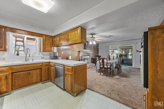 6309 Desert Hills Ave, Bakersfield, CA 93309 - kitchen with dishwasher, brown cabinetry, a peninsula, ceiling fan, and light countertops