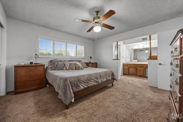 6309 Desert Hills Ave, Bakersfield, CA 93309 - bedroom featuring a textured ceiling, light carpet, ensuite bath, and a ceiling fan