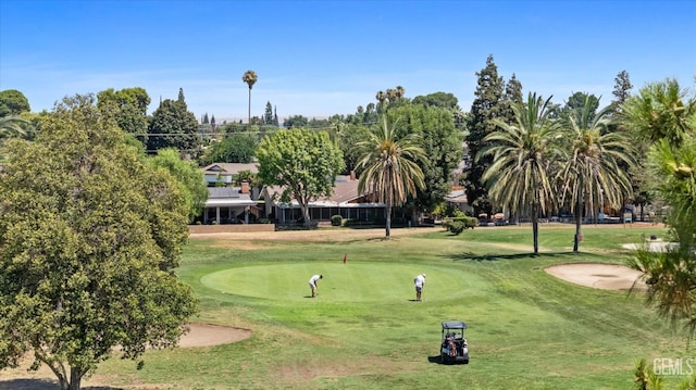 6309 Desert Hills Ave, Bakersfield, CA 93309 - view of property's community with view of golf course, a lawn, and a putting area