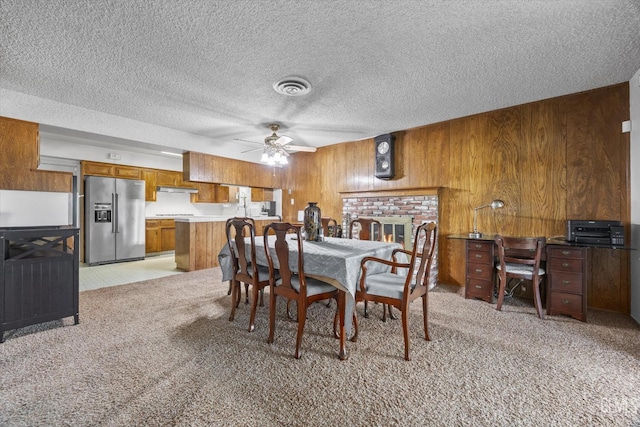 6309 Desert Hills Ave, Bakersfield, CA 93309 - dining space with light colored carpet, a ceiling fan, wooden walls, a textured ceiling, and an office area