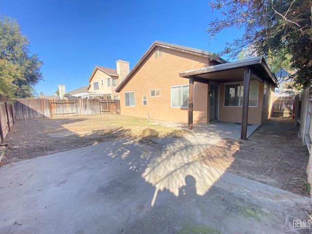 5217 Clover Mountain St, Bakersfield, CA 93313 - rear view of property with stucco siding, a fenced backyard, and a patio area