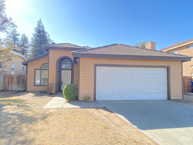 5217 Clover Mountain St, Bakersfield, CA 93313 - view of front facade with driveway, a chimney, and a garage