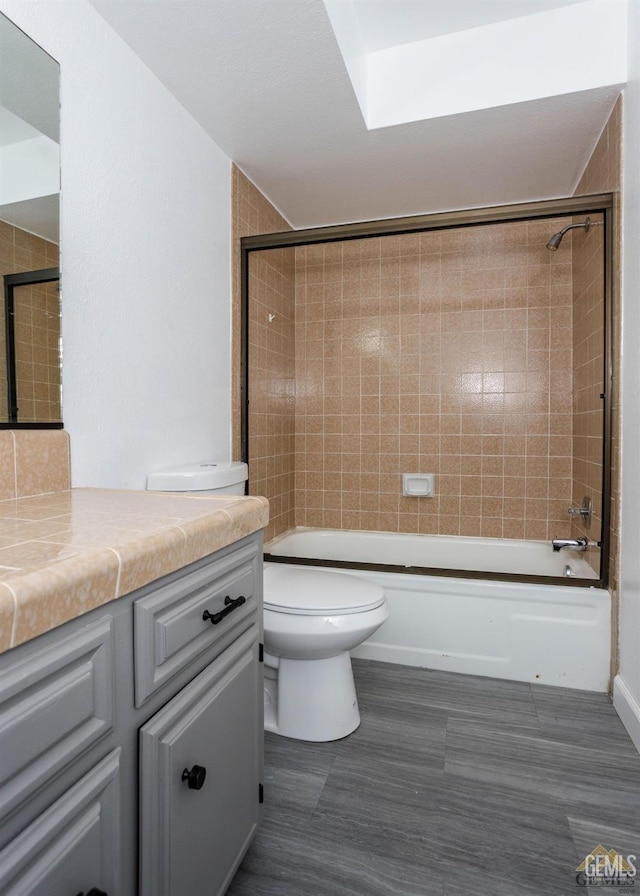 full bathroom featuring vanity, toilet, and tiled shower / bath combo